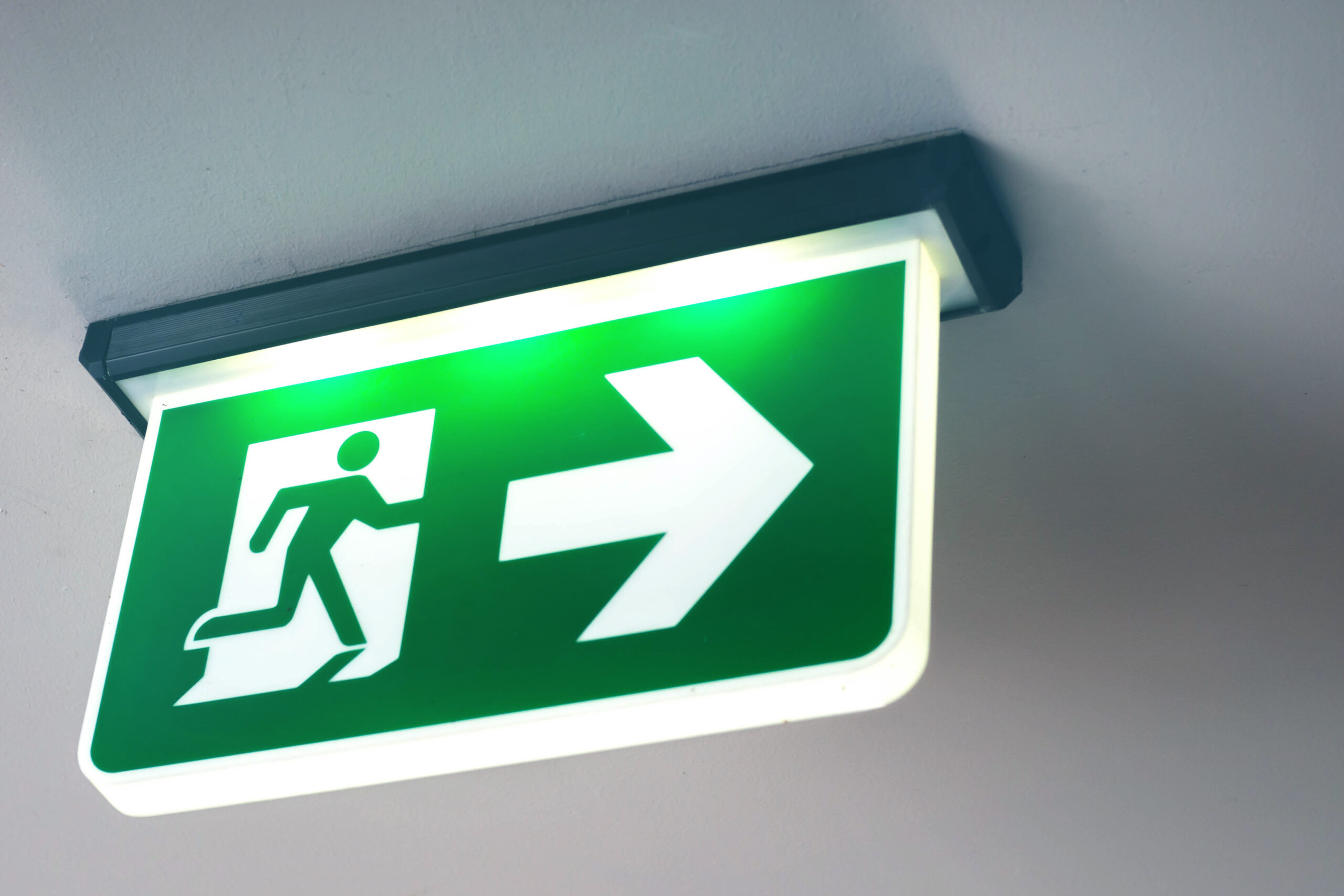 Fire exit sign hanging from ceiling